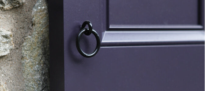 Closeup photo of exterior shutter pull ring installed on purple panel shutter.
