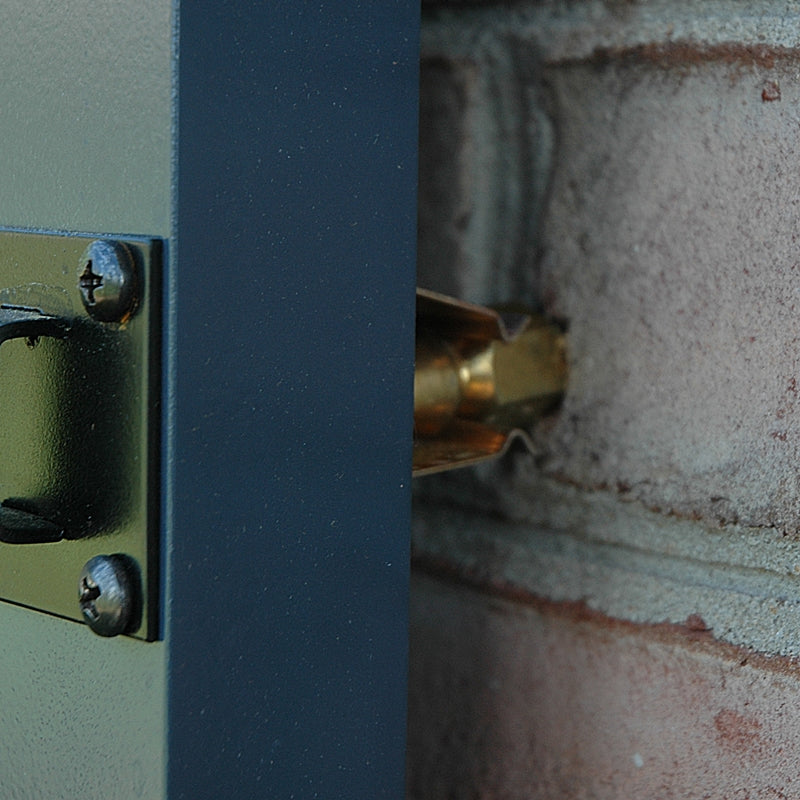 Closeup of installed Bullet Catch on blue shutter and brick.