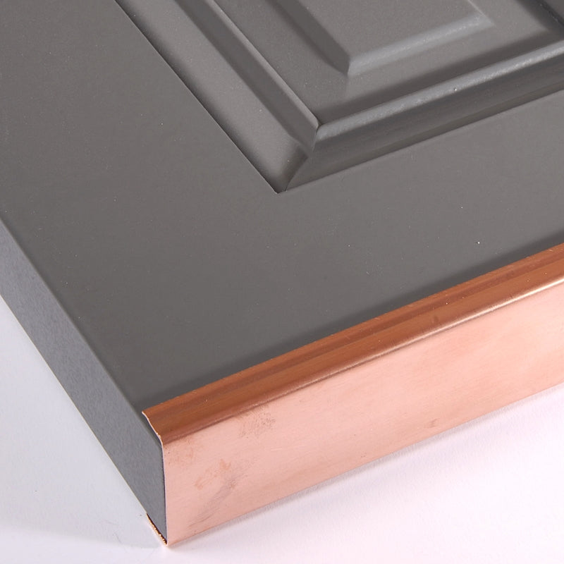 Closeup of Copper Shutter Capping installed on raised panel gray shutter.