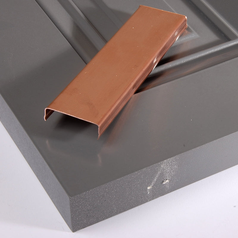 Closeup of Copper Shutter Capping on top of gray raised panel shutter.